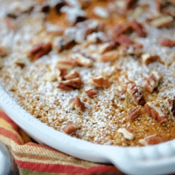 a close up of pumpkin oatmeal in a white baking dish