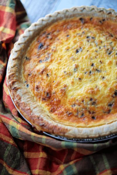 a pie crust with bacon and cheddar cheese quiche
