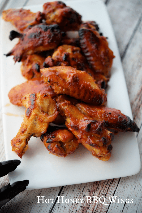 a plate of hot honey bbq wings
