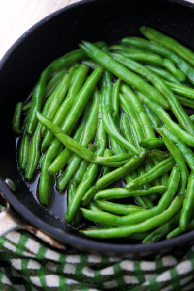 hot honey green beans in a black skillet