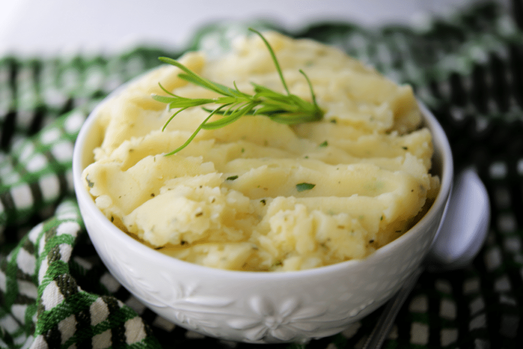 a close up of mashed potatoes in a white bowl