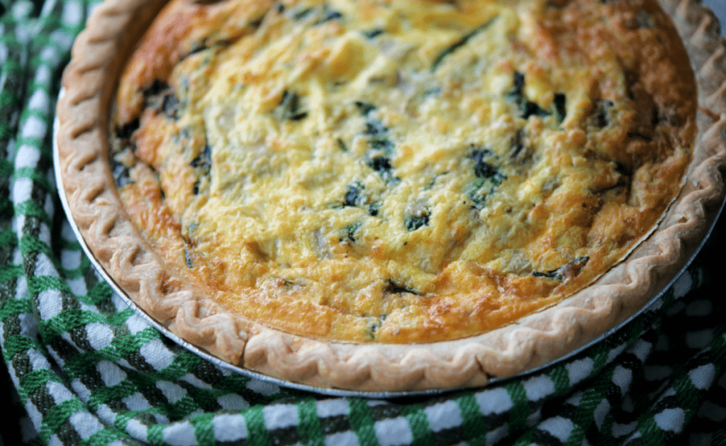 spinach artichoke quiche on a green napkin