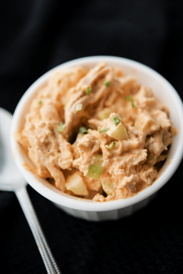 a white bowl filled with buffalo style chicken salad