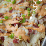 nachos topped with corned beef, sauerkraut and cheese