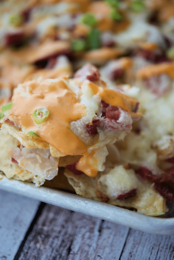 a close up of tortilla chips topped with corned beef