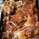 pull part bread in a loaf pan with cured meats and cheese