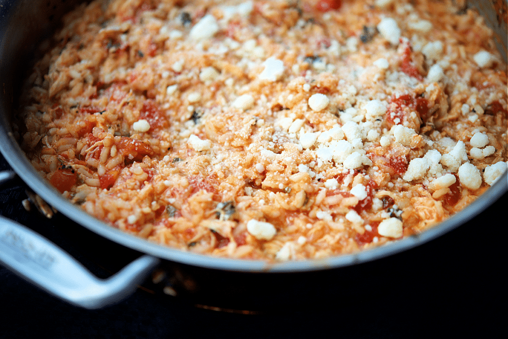 a close up of chicken parmesan risotto in a skillet