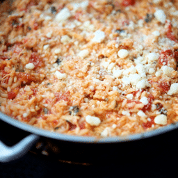 a close up of chicken parmesan risotto in a skillet