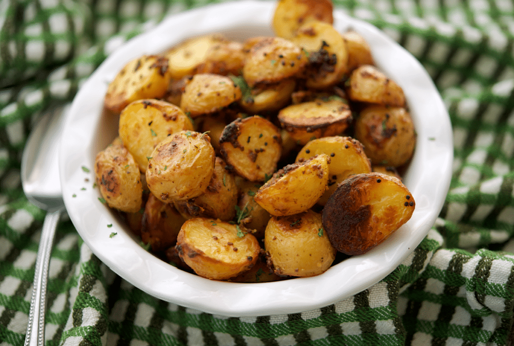a close up of mustard roasted baby potatoes