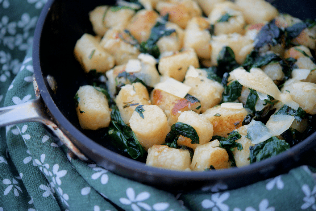 a close up of cauliflower gnocchi in a skillet