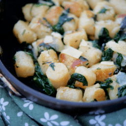 a close up of cauliflower gnocchi in a skillet