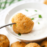 buffalo chicken meatballs on a fork with ranch dip