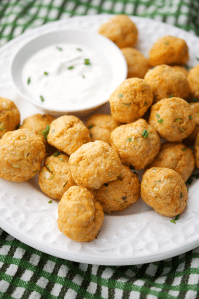 buffalo chicken meatballs on a white plate with dip