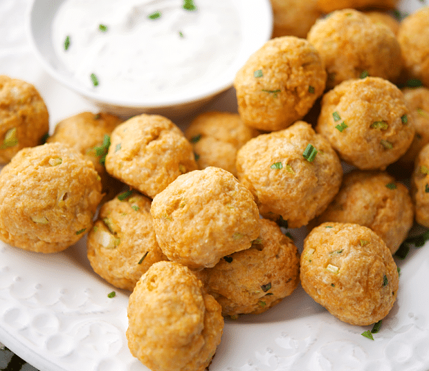 buffalo chicken meatballs on a white plate with dip