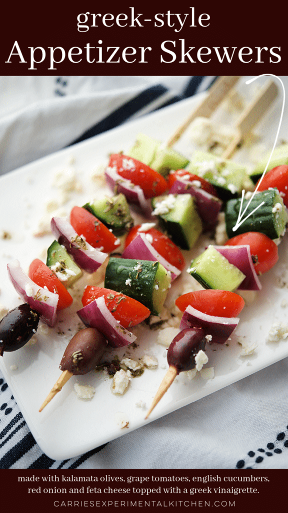 greek style appetizer skewers on a white platter