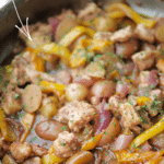 chicken murphy in a skillet with peppers, onions and potatoes