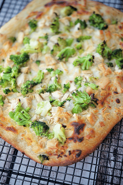 chicken and broccoli flatbread pizza on a wire rack