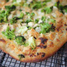 a close up of chicken broccoli flatbread