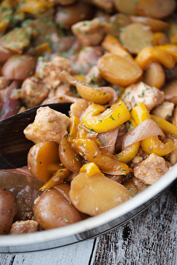 chicken potatoes and peppers in a skillet