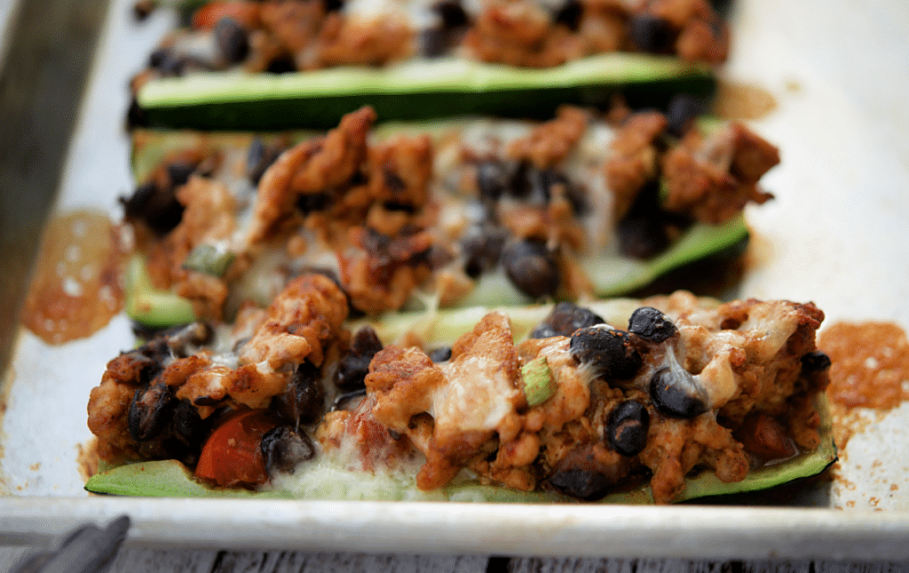 a close up of chicken taco zucchini boats