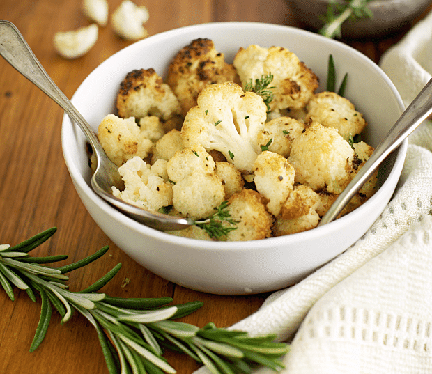 italian roasted cauliflower in a bowl with a spoon