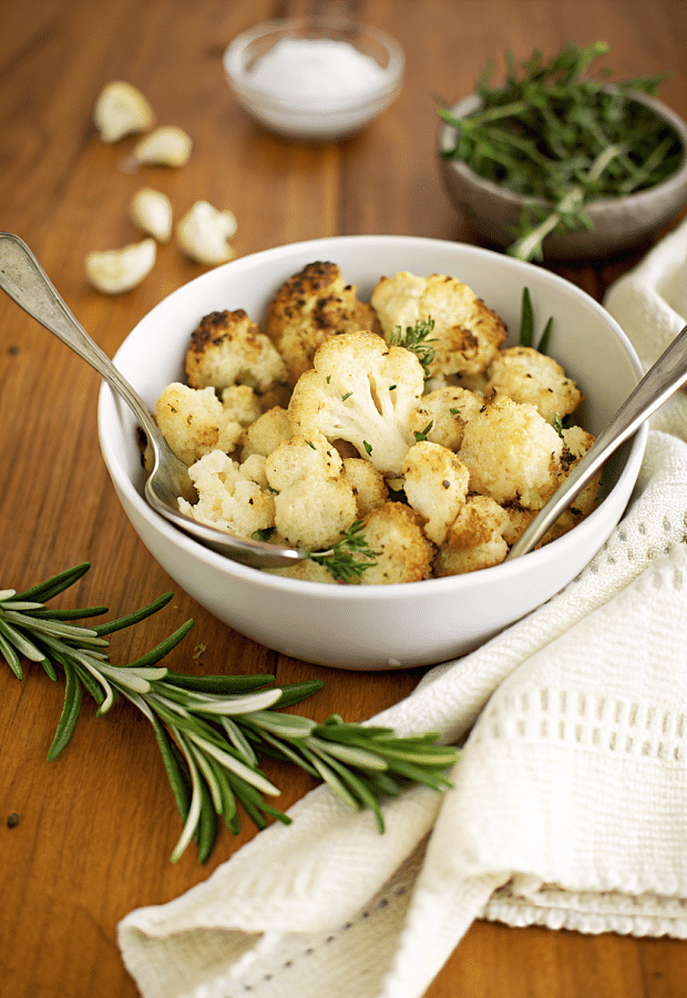 italian roasted cauliflower in a bowl with a spoon