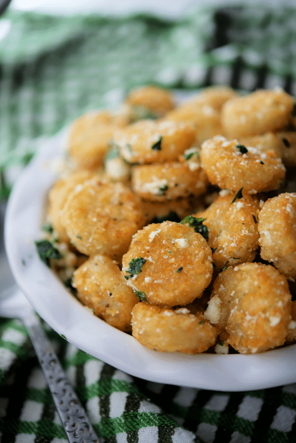 tater tots with garlic and parmesan in a bowl