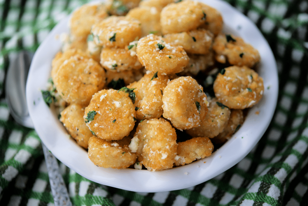 a close up of a dish of tater tots