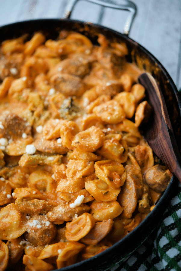 a pan with cooked tortellini and sausage