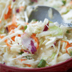 a spoon in a bowl of asian style coleslaw