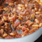 a close up of brisket chili in a white dutch oven