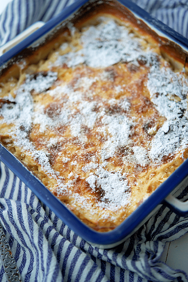 Peaches and cream baked oatmeal in a white and blue dish