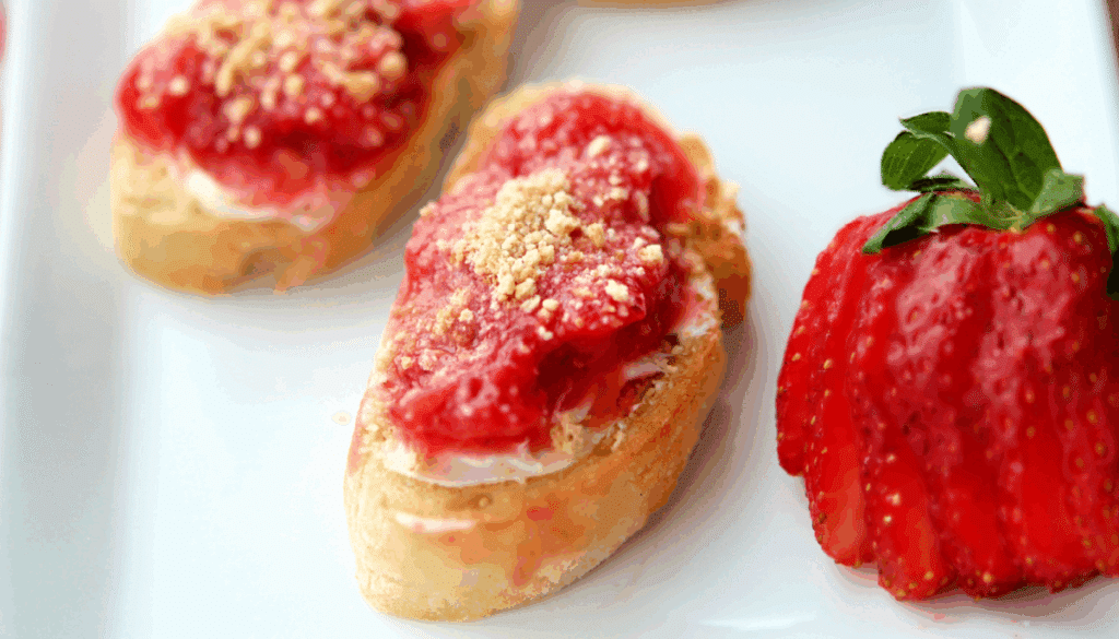 a close up of strawberry shortcake crostini with fresh strawberries