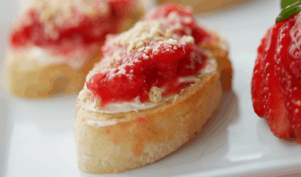 a close up of crostini with strawberry puree