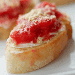 a close up of crostini with strawberry puree
