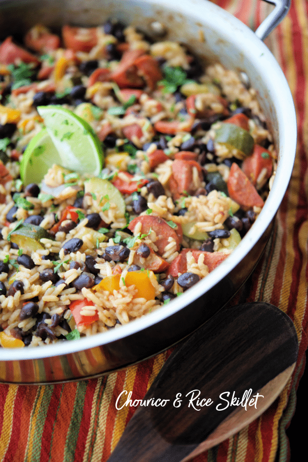 a skillet with beans rice and chourico