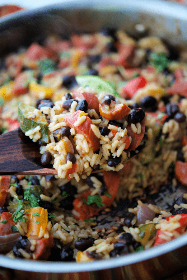 a close up of chourico and rice skillet on a spoon