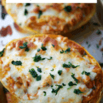 cooked chicken parmesan spaghetti squash on a sheet pan