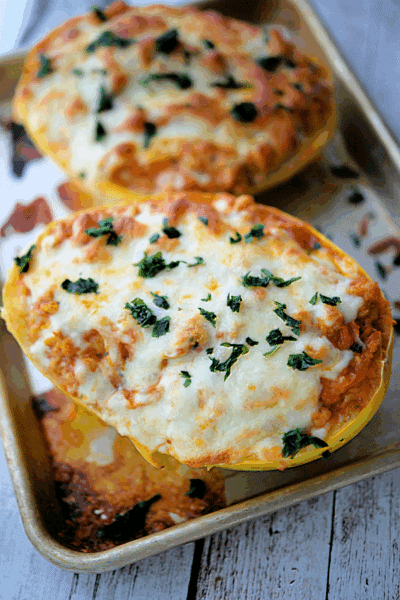 two stuffed chicken parmesan spaghetti squash boats
