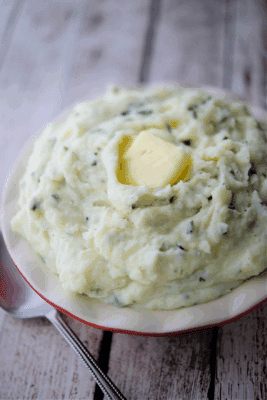 ricotta and basil whipped potatoes in a bowl