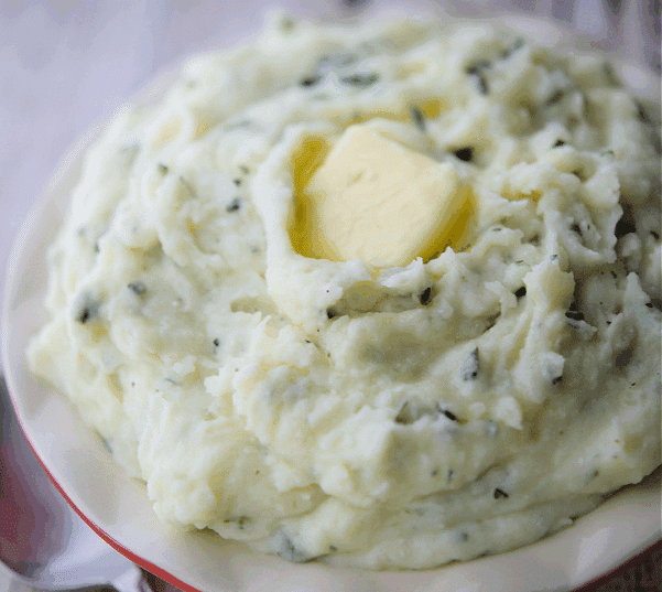 ricotta and basil whipped potatoes in a bowl
