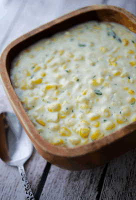 a wood bowl filled with rosemary creamed corn