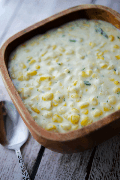 a wood bowl filled with rosemary creamed corn