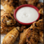 lemon pepper chicken wings in a plate with dip