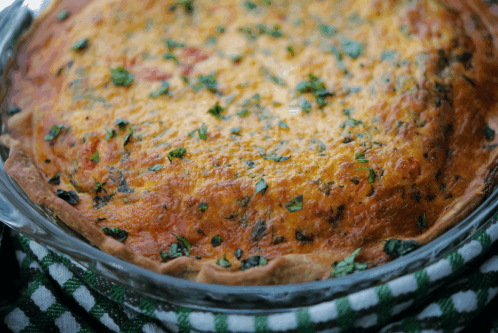 a close up of tomato caprese quiche