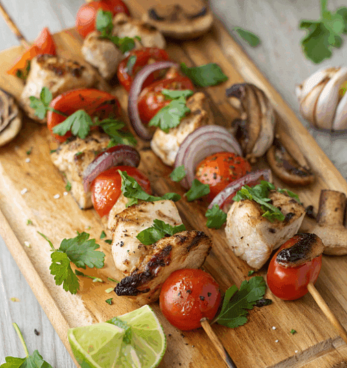 chicken skewers grilled on a wood cutting board